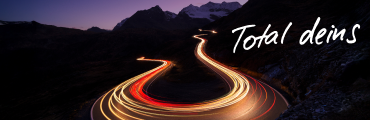 A1 Breitband Internet Speed Upgrade dunkle Serpentinenstraße mit Autolichtern