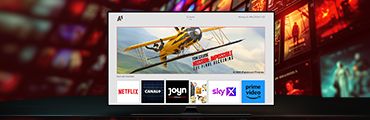 Smart-TV mit Streaming-Diensten wie Netflix, Canal+, Joyn, Sky X und Prime Video, Filmvorschau zeigt gelbes Flugzeug.